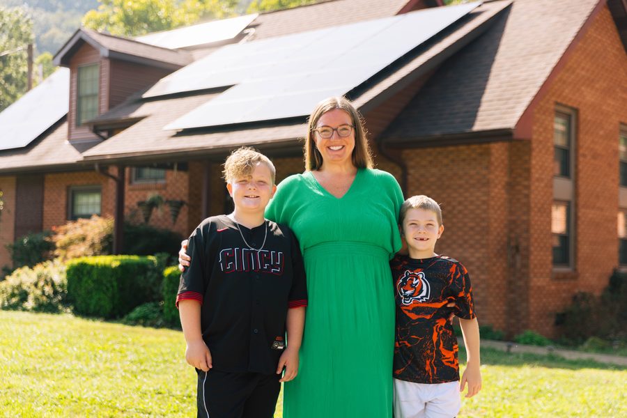 Solar Holler customer family in front of their home with solar panels