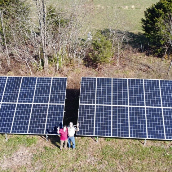 Bobby and Lori Fore waving, Solar Panel Array, Kentucky,